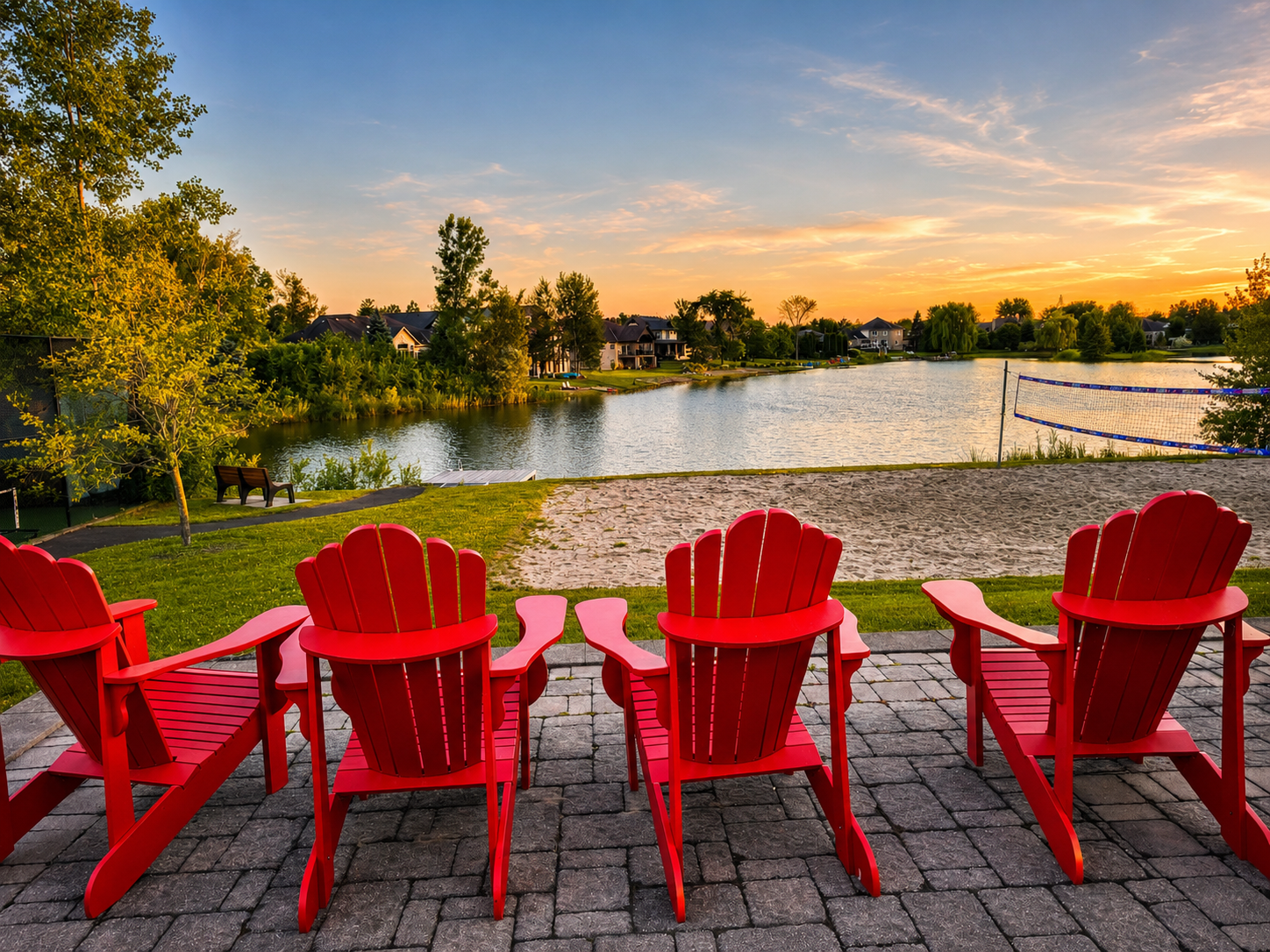Red chairs facing the lake at sunset