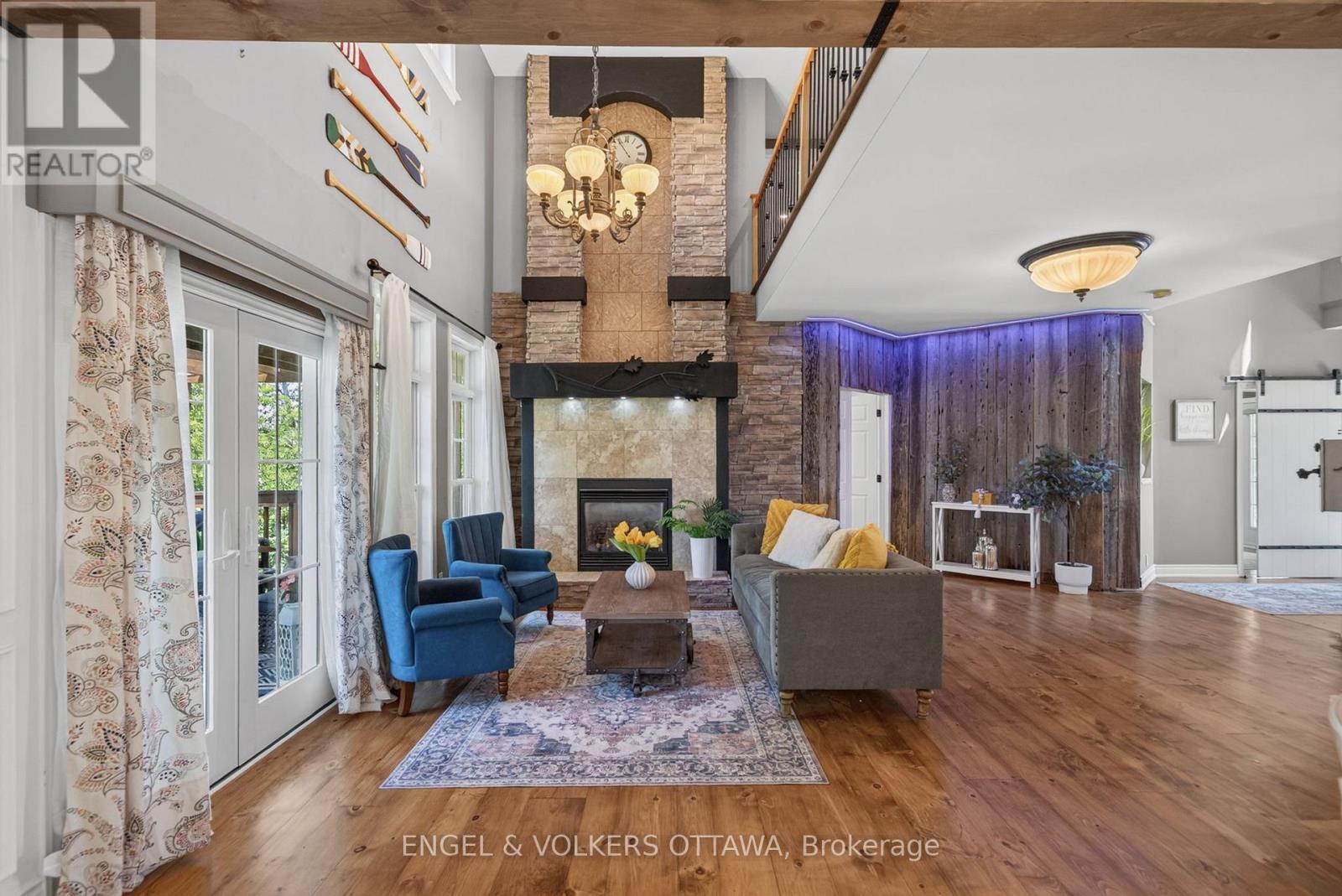 Two-storey stone fireplace living room